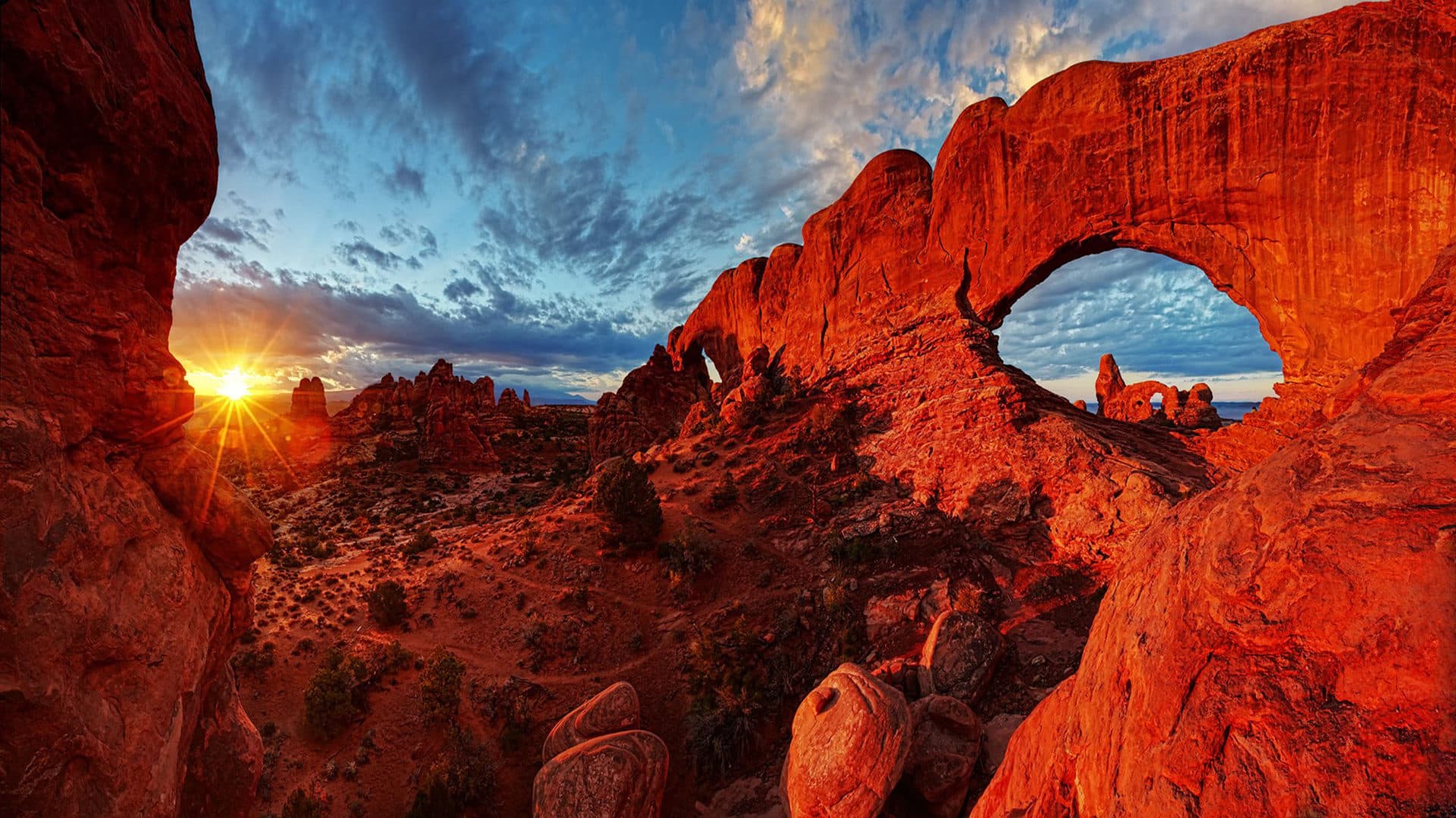 Dramatic sunset through ancient stone arches